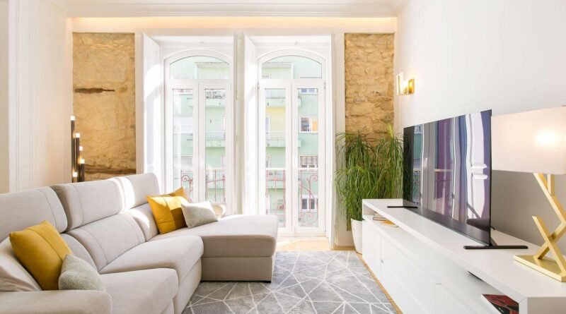 Sala com luz natural e decorada com tons neutros e amarelo